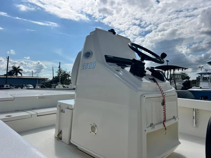Slide: The Image of 2025 Pathfinder 2500 Hybrid boat console under a partly cloudy sky. - 7