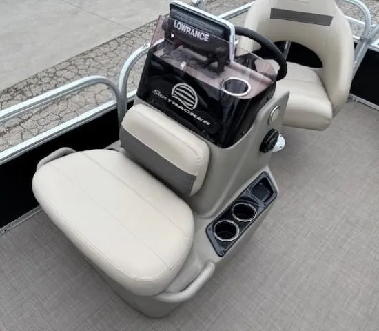 Slide: The Image of 2021 Sun Tracker Bass Buggy 16 XL boat console with steering wheel and cup holders. - 12