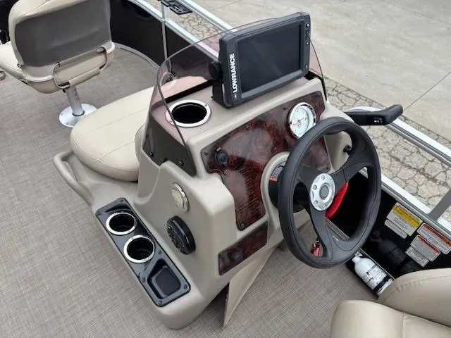Slide: The Image of 2021 Sun Tracker Bass Buggy 16 XL boat console with steering wheel and navigation system. - 14