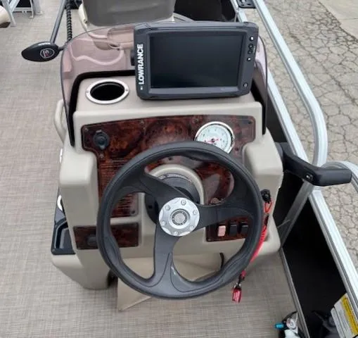 Slide: The Image of 2021 Sun Tracker Bass Buggy 16 XL dashboard with steering wheel and Lowrance fish finder. - 15
