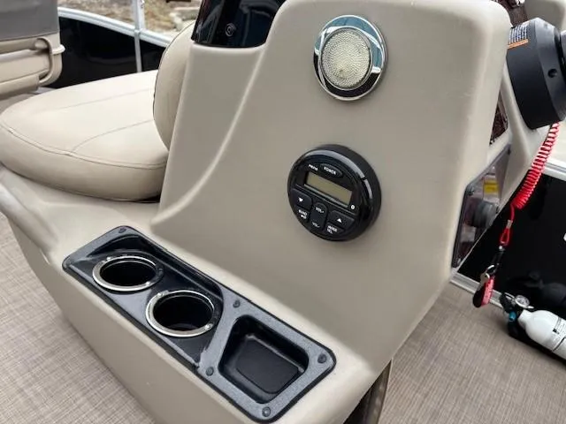 Slide: The Image of 2021 Sun Tracker Bass Buggy 16 XL console with cup holders and control panel. - 17