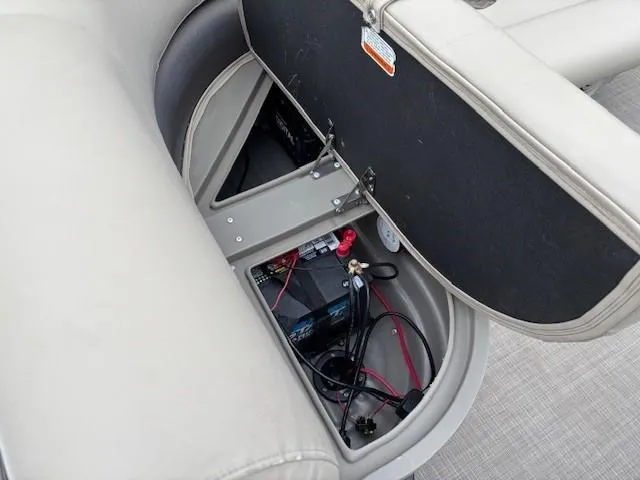 Slide: The Image of 2021 Sun Tracker Bass Buggy 16 XL boat battery compartment with wiring and storage. - 21