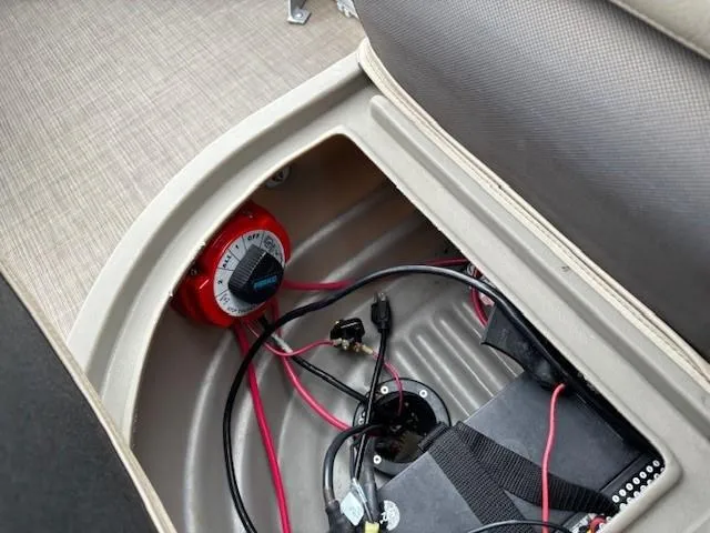 Slide: The Image of Battery compartment of 2021 Sun Tracker Bass Buggy 16 XL with wiring and switch. - 23