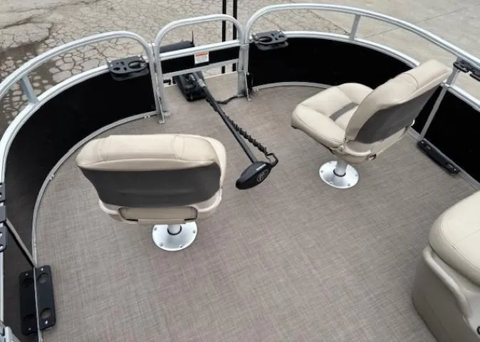 Slide: The Image of 2021 Sun Tracker Bass Buggy 16 XL interior with two swivel seats and trolling motor. - 6