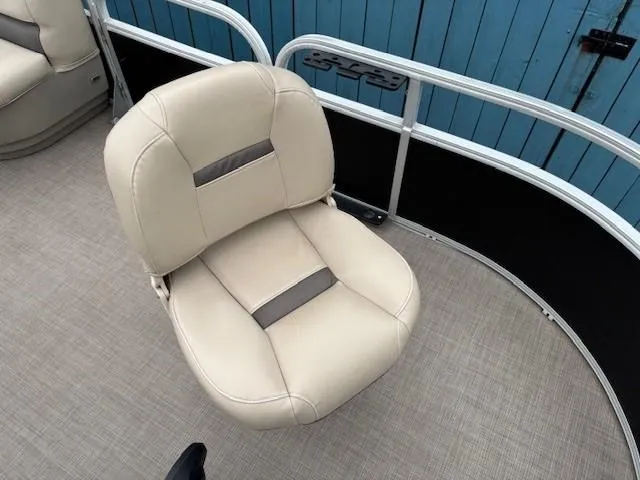 Slide: The Image of 2021 Sun Tracker Bass Buggy 16 XL boat seat, beige upholstery, blue background. - 8