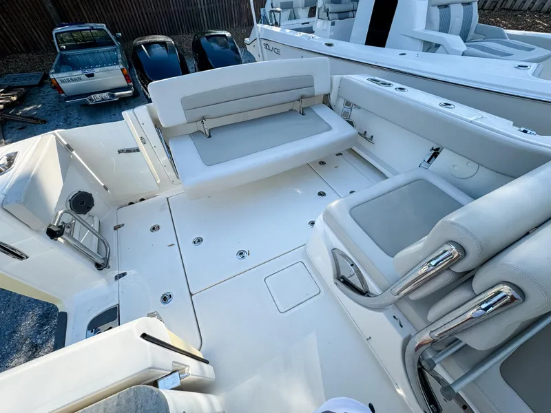 Slide: The Image of 2017 Boston Whaler 320 Vantage boat interior with seating and storage features. - 11