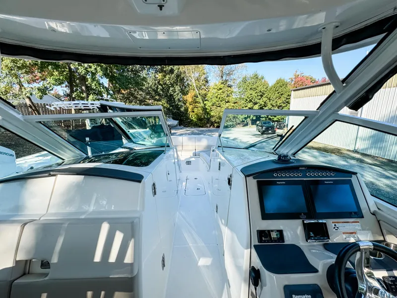 Slide: The Image of 2017 Boston Whaler 320 Vantage boat interior with dual consoles and navigation screens. - 15