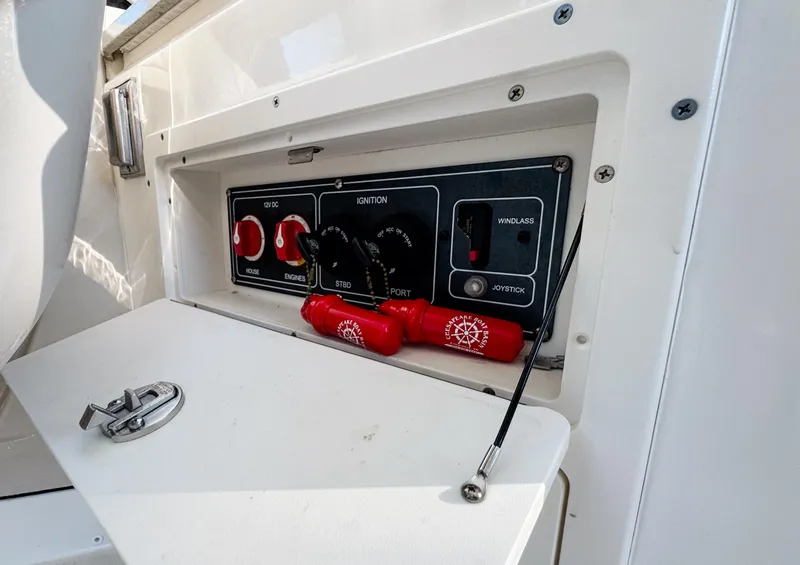 Slide: The Image of Control panel of a 2017 Boston Whaler 320 Vantage boat, featuring ignition and switches. - 18