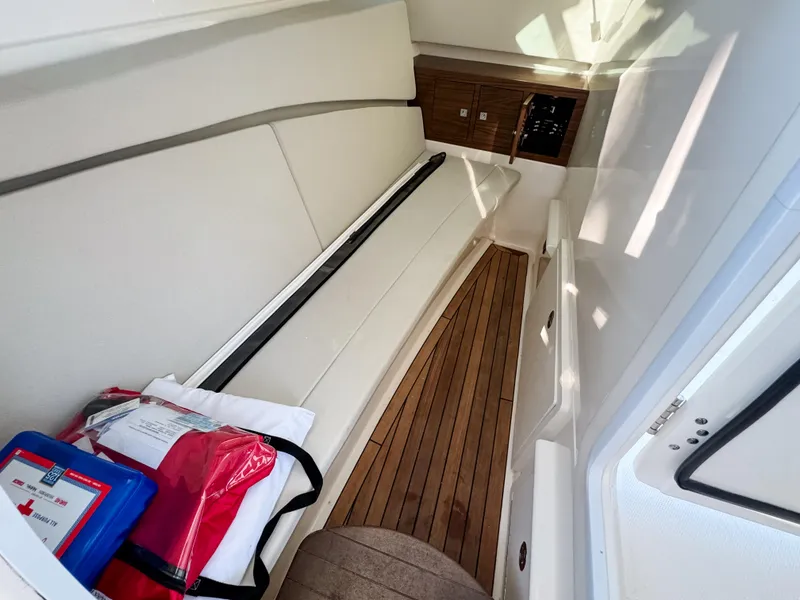 Slide: The Image of 2017 Boston Whaler 320 Vantage interior with seating and wooden flooring. - 19