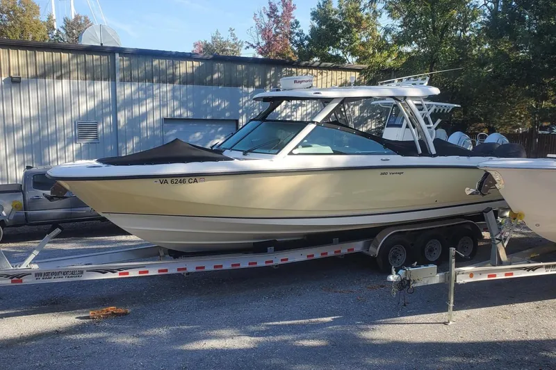 Slide: The Image of 2017 Boston Whaler 320 Vantage boat on trailer, parked outdoors. - 2