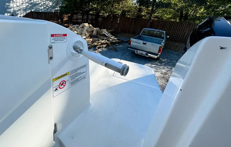 Slide: The Image of 2017 Boston Whaler 320 Vantage boat deck with safety warnings, parked truck in background. - 6