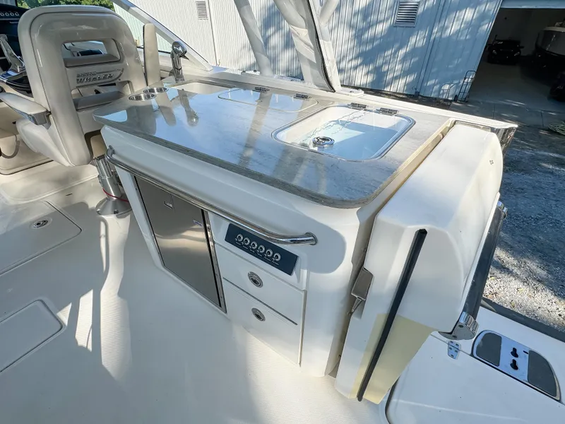Slide: The Image of 2017 Boston Whaler 320 Vantage boat interior with kitchenette and storage drawers. - 8