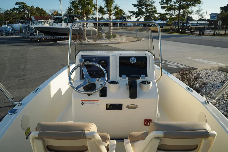 Slide: The Image of 2025 Scout 175 Sportfish boat interior with steering wheel and control panel. - 12