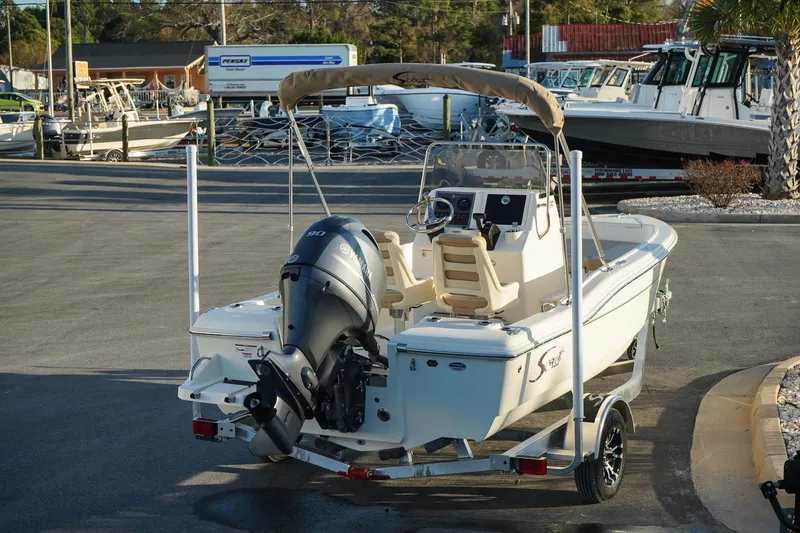 Slide: The Image of 2025 Scout 175 Sportfish boat on trailer, parked in marina lot. - 7