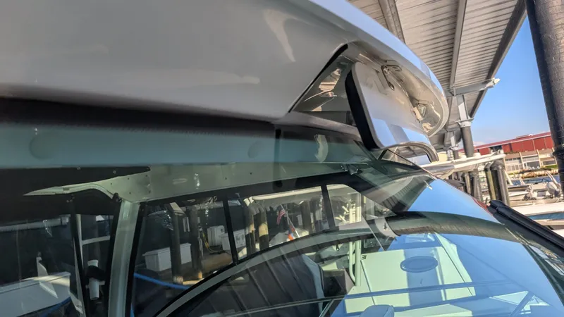 Slide: The Image of 2014 Boston Whaler 315 Conquest boat detail under a covered dock. - 14