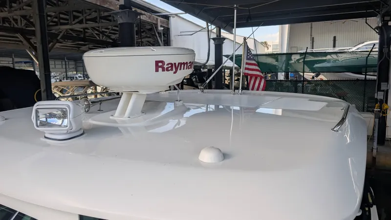 Slide: The Image of 2014 Boston Whaler 315 Conquest boat roof with Raymarine radar and American flag. - 16