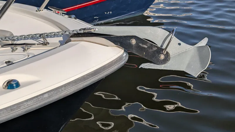 Slide: The Image of 2014 Boston Whaler 315 Conquest anchor detail on calm water. - 20