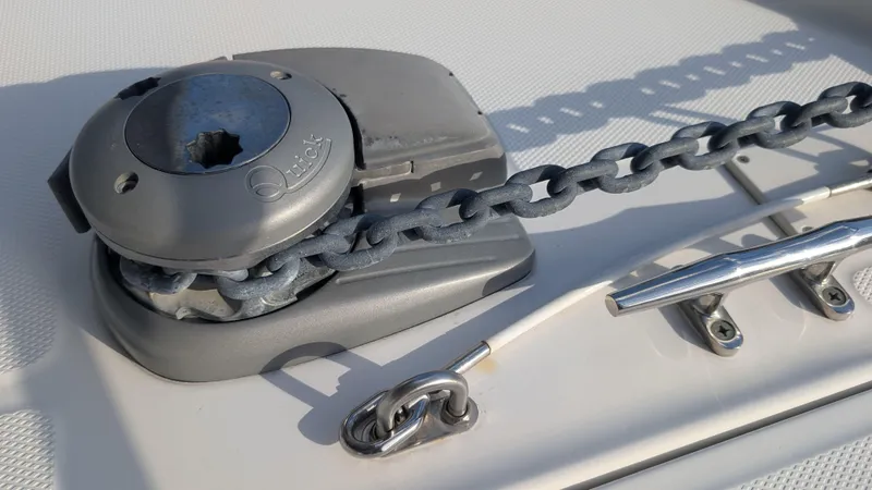 Slide: The Image of Anchor windlass and chain on 2014 Boston Whaler 315 Conquest boat deck. - 21