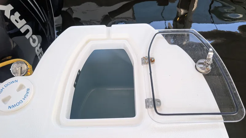 Slide: The Image of Open hatch on 2014 Boston Whaler 315 Conquest boat, showing storage compartment. - 27