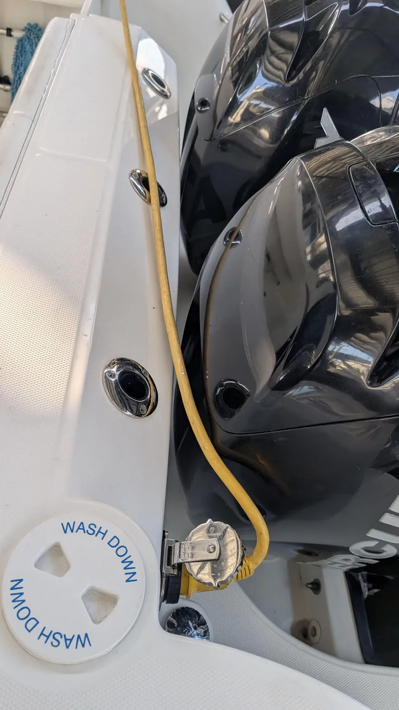 Slide: The Image of 2014 Boston Whaler 315 Conquest boat with dual engines and wash down feature. - 28