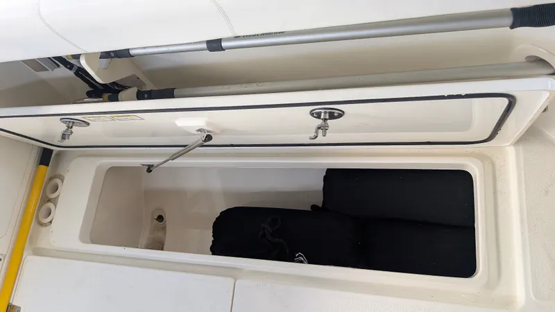 Slide: The Image of Open storage compartment on a 2014 Boston Whaler 315 Conquest boat. - 30