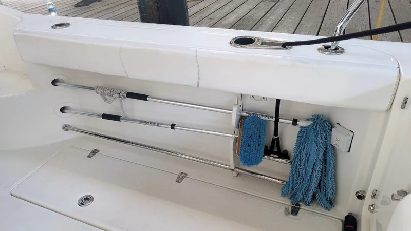 Slide: The Image of Storage area on a 2014 Boston Whaler 315 Conquest boat with cleaning tools. - 31