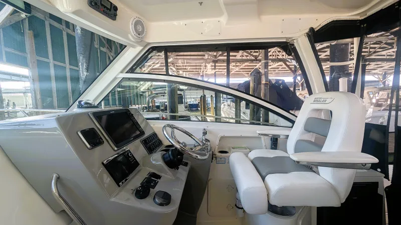 Slide: The Image of 2014 Boston Whaler 315 Conquest helm with modern controls and comfortable seating. - 41