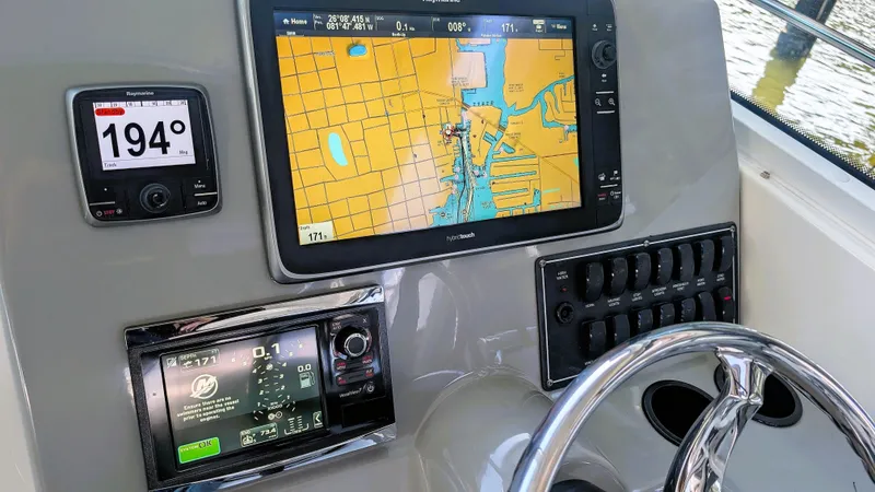 Slide: The Image of Dashboard of 2014 Boston Whaler 315 Conquest with navigation and control systems. - 43