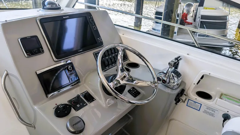 Slide: The Image of 2014 Boston Whaler 315 Conquest helm with modern navigation and control systems. - 44
