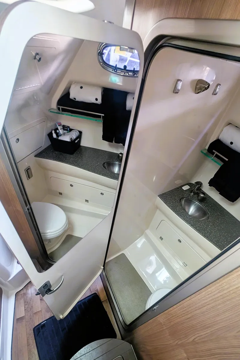 Slide: The Image of 2014 Boston Whaler 315 Conquest bathroom with sink, toilet, and storage. - 49