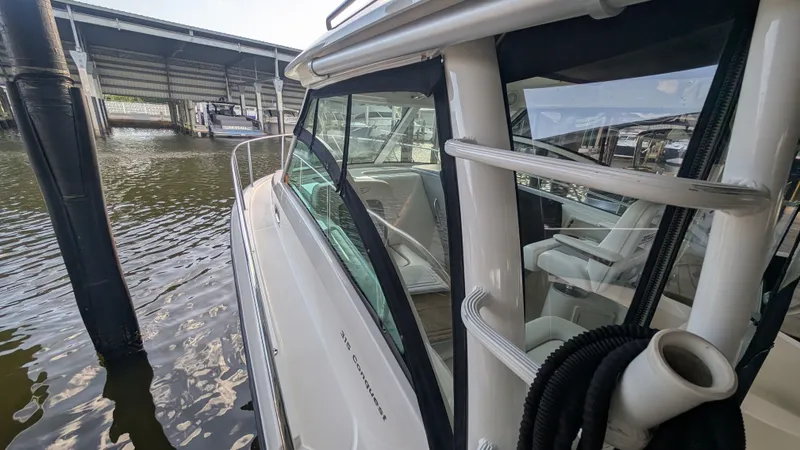 Slide: The Image of 2014 Boston Whaler 315 Conquest docked, showcasing sleek design and spacious interior. - 5