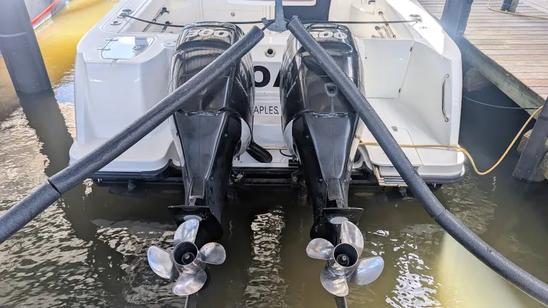 Slide: The Image of 2014 Boston Whaler 315 Conquest with twin outboard engines docked at marina. - 7
