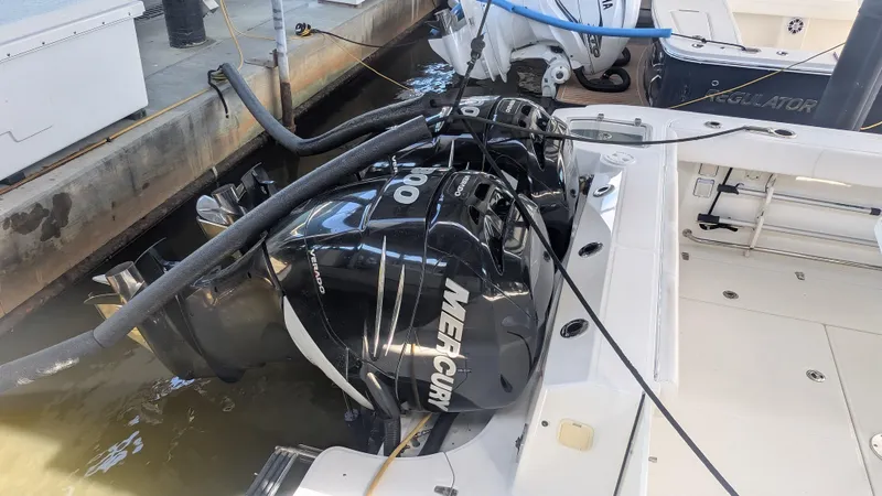 Slide: The Image of Twin Mercury outboard engines on a 2014 Boston Whaler 315 Conquest boat at dock. - 8