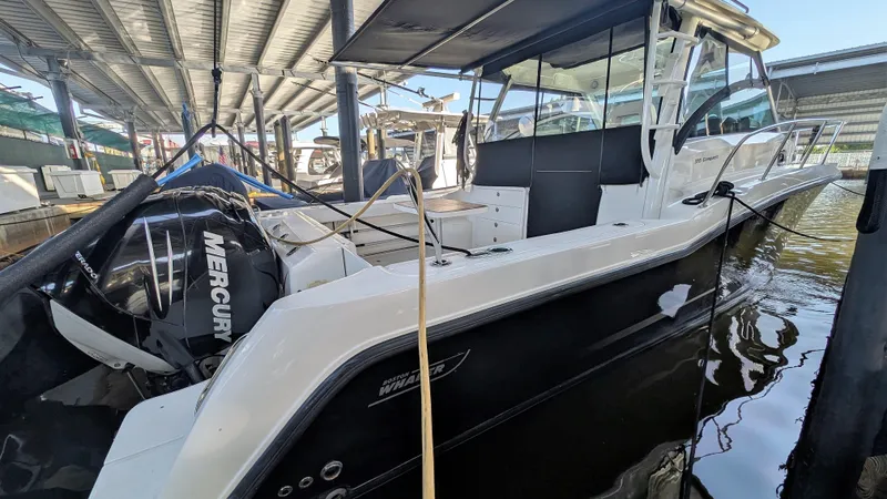 Slide: The Image of 2014 Boston Whaler 315 Conquest boat docked with Mercury engine. - 9