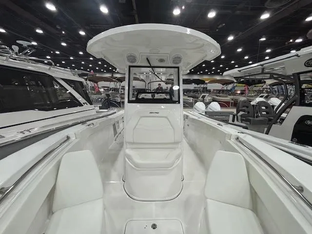 Slide: The Image of 2025 Sea Pro 262 Offshore boat interior at a boat show, showcasing seating and helm. - 23