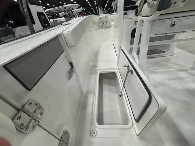Slide: The Image of 2025 Sea Pro 262 Offshore boat on trailer in garage setting. - 6