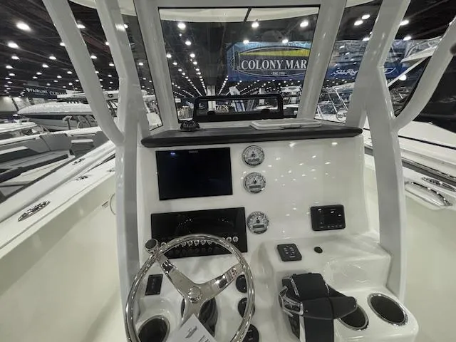 Slide: The Image of 2025 Sea Pro 262 Offshore boat with dual Mercury engines on trailer in showroom. - 8