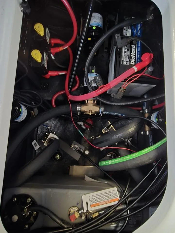 Slide: The Image of 2025 Nautique Super Air Nautique G23 engine compartment with battery and wiring components. - 11