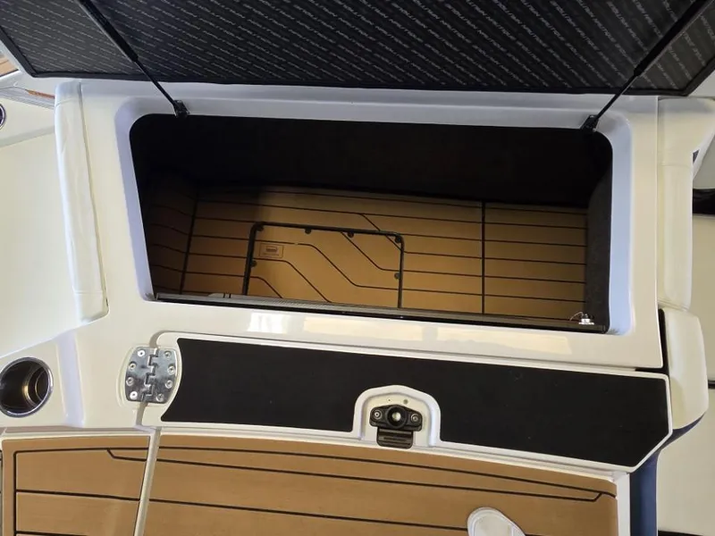 Slide: The Image of Open storage compartment on 2025 Nautique Super Air Nautique G23 boat. - 16