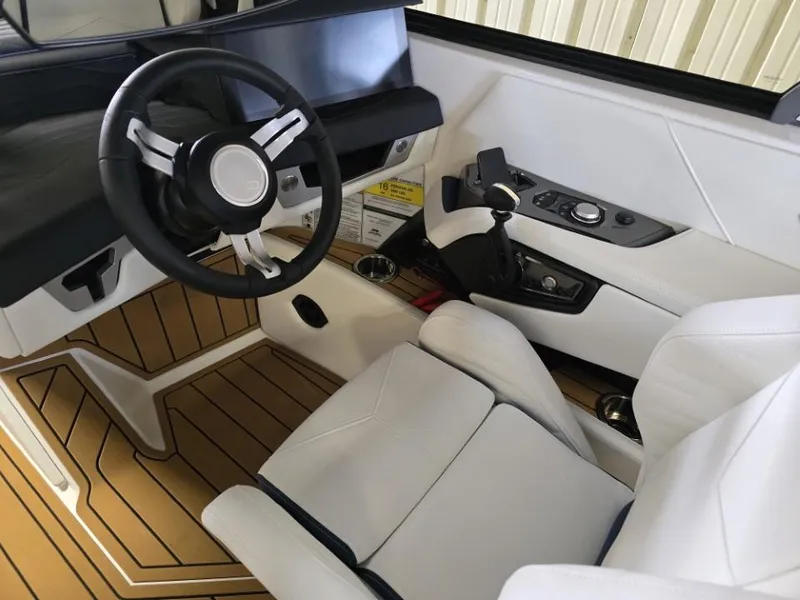 Slide: The Image of 2025 Nautique Super Air Nautique G23 interior with sleek steering and modern controls. - 19