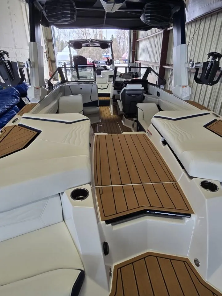 Slide: The Image of 2025 Nautique Super Air Nautique G23 interior with sleek seating and wood accents. - 22