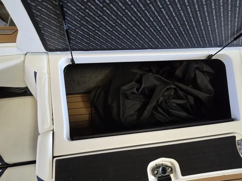 Slide: The Image of Open storage compartment in 2025 Nautique Super Air Nautique G23 boat. - 25
