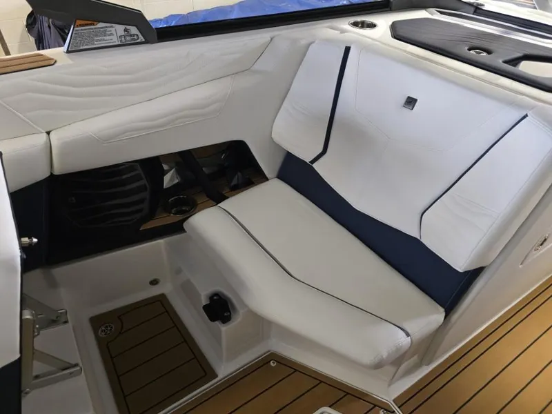 Slide: The Image of 2025 Nautique Super Air Nautique G23 interior seating with white upholstery and sleek design. - 28