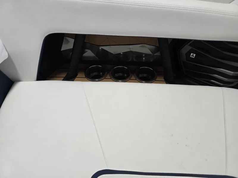 Slide: The Image of Interior of 2025 Nautique Super Air Nautique G23 with cup holders and speaker. - 32