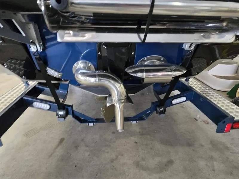 Slide: The Image of 2025 Nautique Super Air Nautique G23 boat stern with propeller and exhaust system. - 33