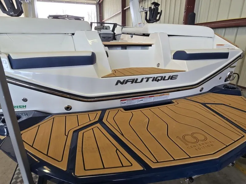 Slide: The Image of 2025 Nautique Super Air Nautique G23 boat, Centennial Edition, in a storage facility. - 34