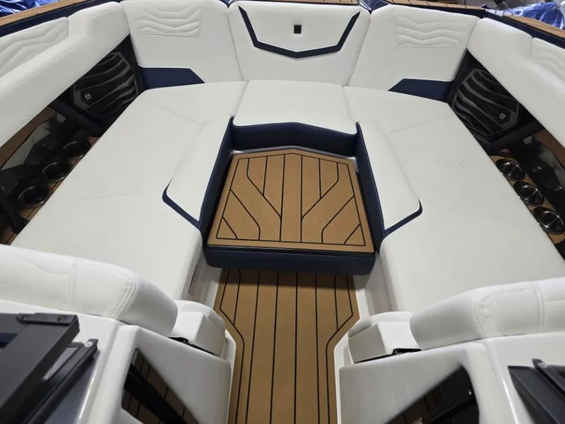 Slide: The Image of 2025 Nautique Super Air Nautique G23 interior with white seating and teak flooring. - 35