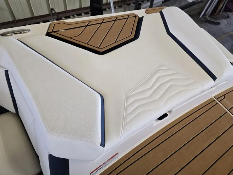 Slide: The Image of 2025 Nautique Super Air Nautique G23 boat interior with sleek white and tan upholstery. - 36