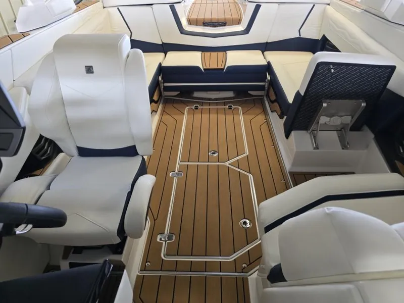 Slide: The Image of 2025 Nautique Super Air Nautique G23 interior with luxurious seating and teak flooring. - 37