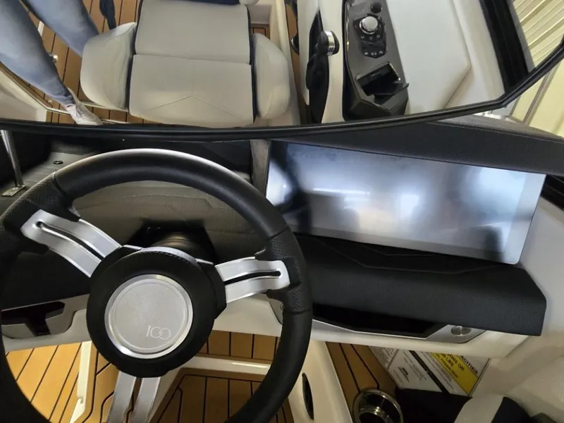 Slide: The Image of 2025 Nautique Super Air Nautique G23 dashboard with steering wheel and control panel. - 39